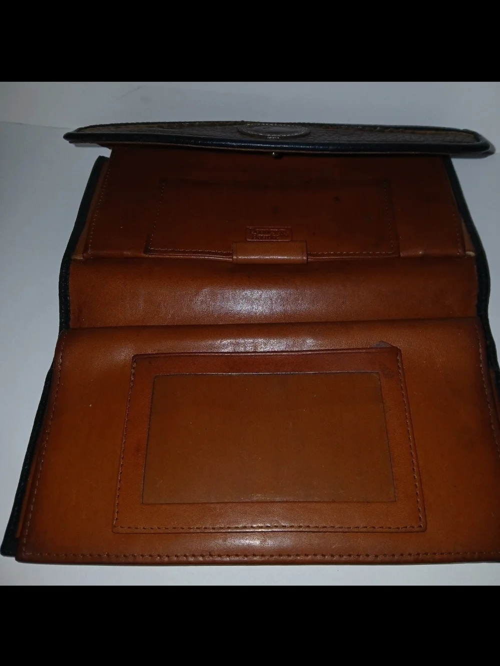 The Dooney & Bourke Black Brown Leather Kisslock Framed Credit Card Trifold